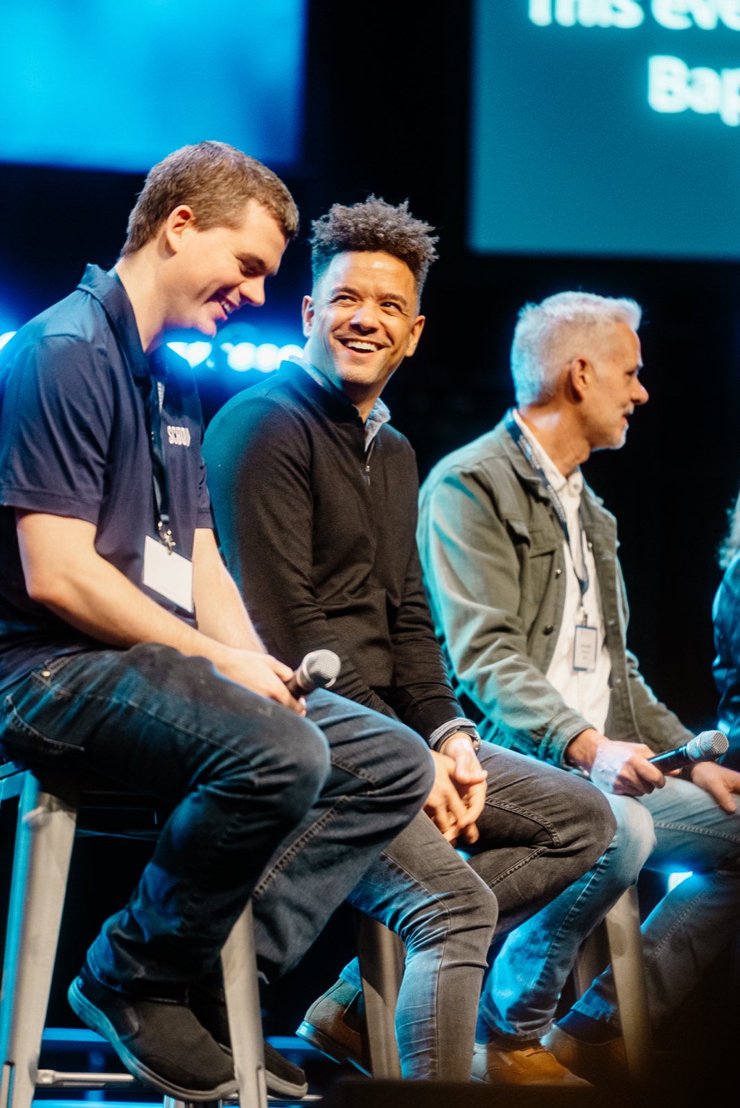Brian Taylor smiling during a panel conversation on stage